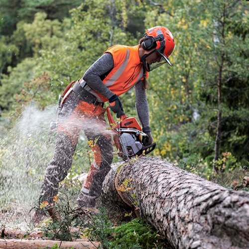 woman using a chainsaw