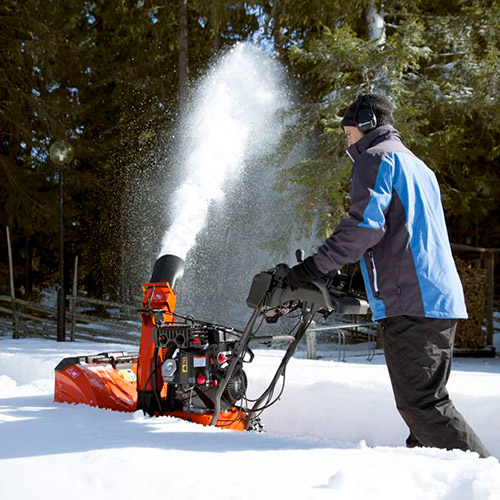 man plowing the snow with a snow thrower